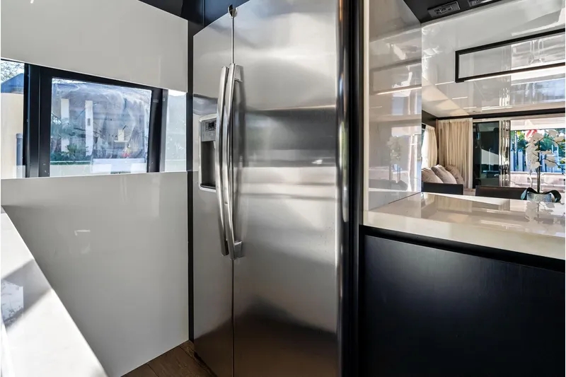 Sunsation Yacht Photos Pics Modern kitchen interior of 2019 Ferretti Yachts 780 with stainless steel refrigerator.