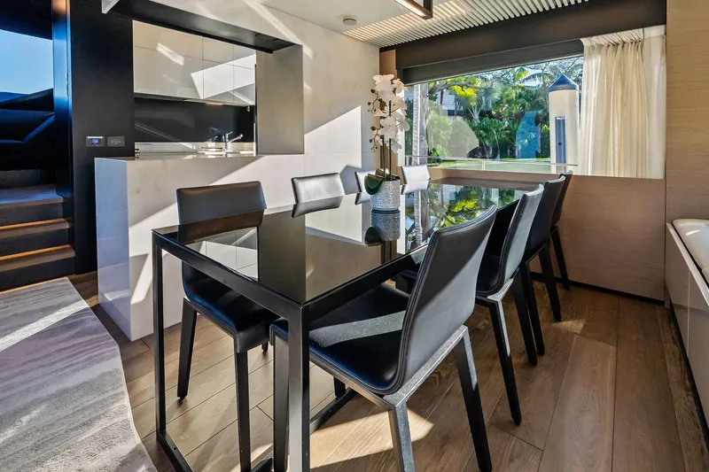 Sunsation Yacht Photos Pics Luxurious dining area on 2019 Ferretti Yachts 780 with modern decor and large window view.