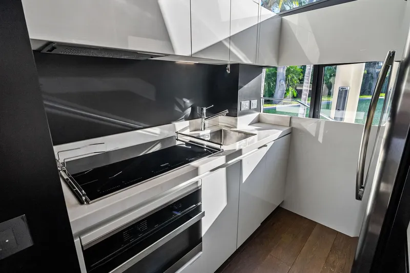 Sunsation Yacht Photos Pics Modern kitchen interior on 2019 Ferretti Yachts 780, featuring sleek design and stainless steel appliances.