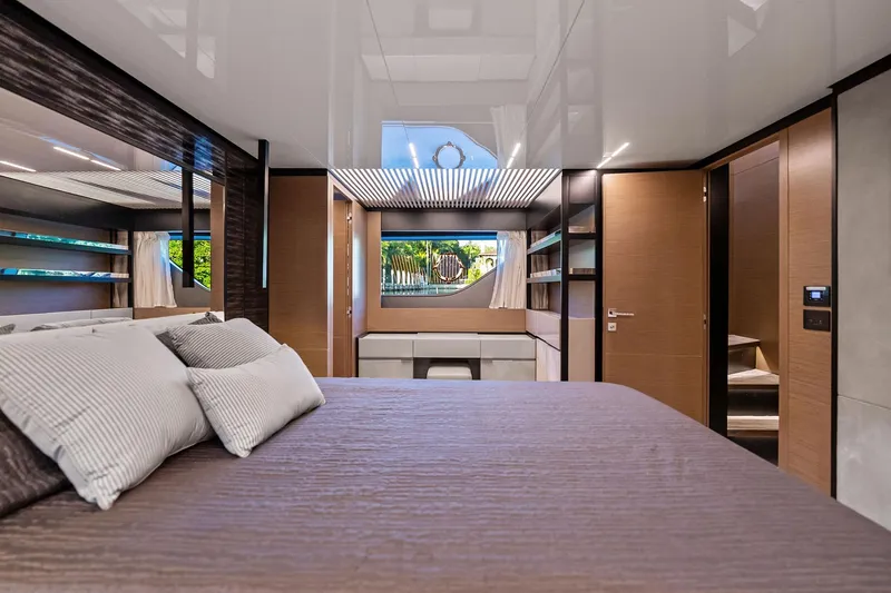 Sunsation Yacht Photos Pics Luxurious bedroom interior of 2019 Ferretti Yachts 780 with modern design and elegant furnishings.