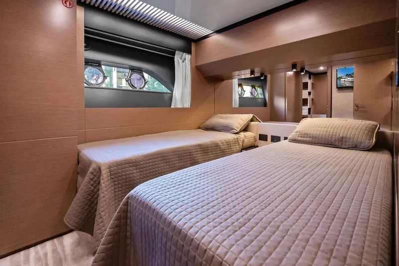 Sunsation Yacht Photos Pics Luxurious twin bedroom in 2019 Ferretti Yachts 780 with modern decor and porthole windows.