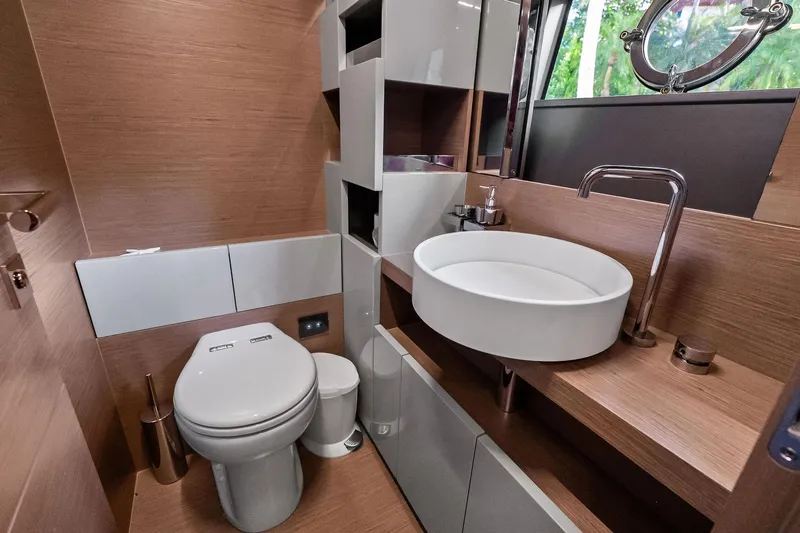 Sunsation Yacht Photos Pics Luxurious bathroom in 2019 Ferretti Yachts 780, featuring modern fixtures and elegant wood finishes.