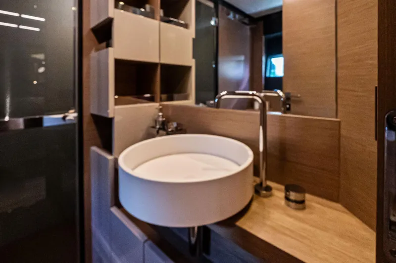 Sunsation Yacht Photos Pics Luxurious bathroom interior of 2019 Ferretti Yachts 780 with modern sink and fixtures.