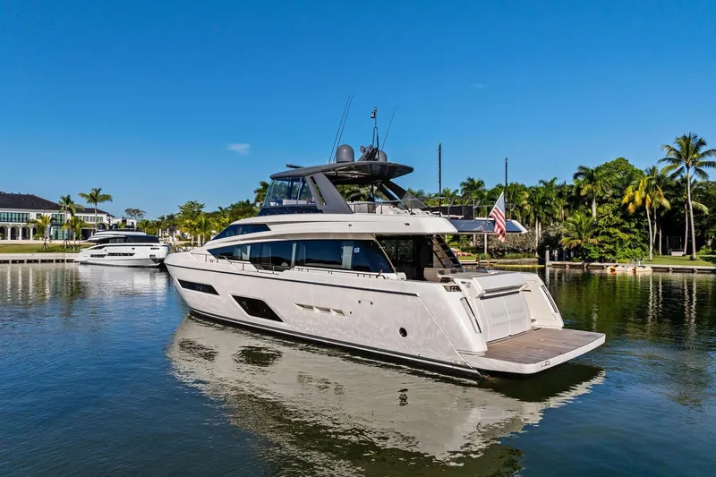 Sunsation Yacht Photos Pics 2019 Ferretti Yachts 780 on serene water, surrounded by lush greenery and clear blue sky.