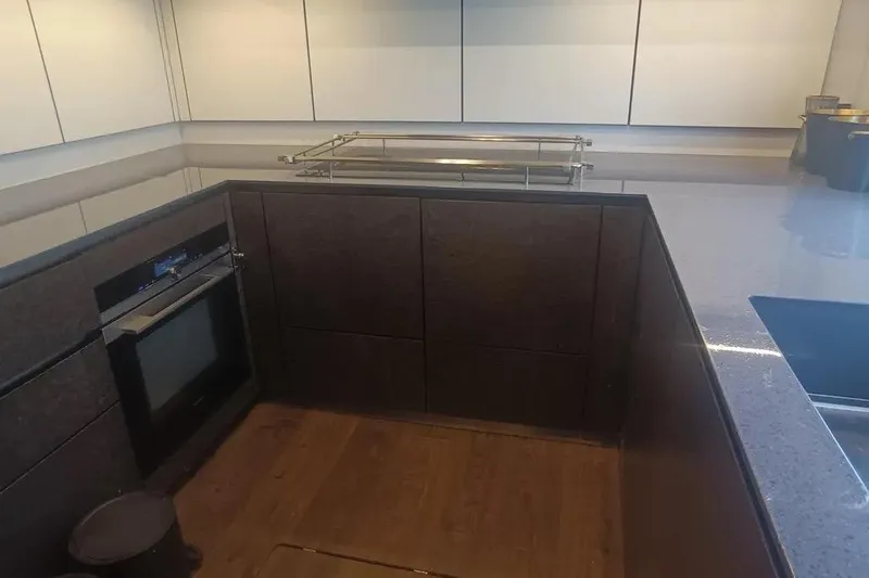  Yacht Photos Pics Modern kitchen interior on 2021 Sunreef 80 Power yacht, featuring sleek cabinetry and appliances.