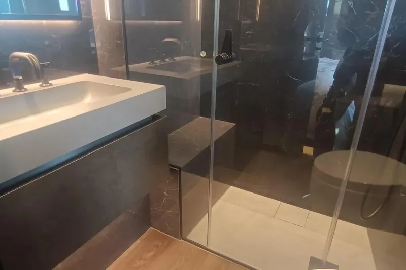  Yacht Photos Pics Luxurious bathroom interior on 2021 Sunreef 80 Power yacht, featuring modern sink and glass shower.