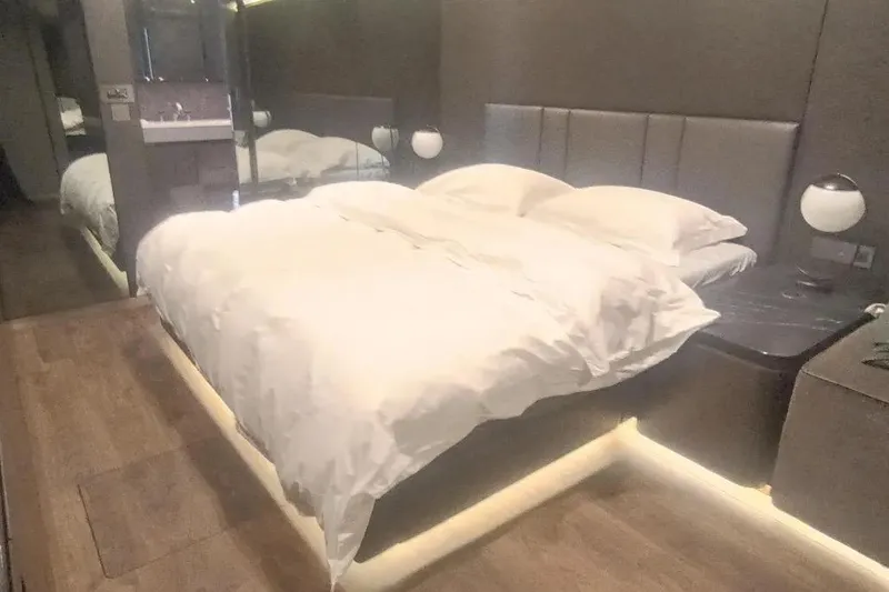  Yacht Photos Pics Luxurious bedroom interior on 2021 Sunreef 80 Power yacht with modern design and ambient lighting.