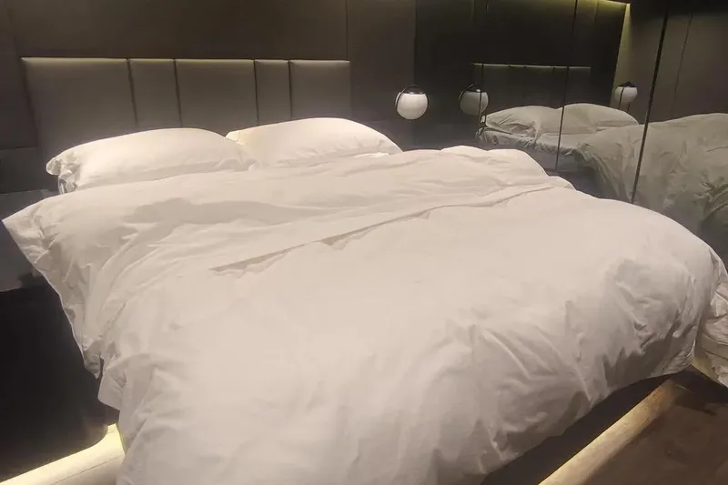  Yacht Photos Pics Luxurious bedroom interior on 2021 Sunreef 80 Power yacht, featuring elegant bedding and modern design.