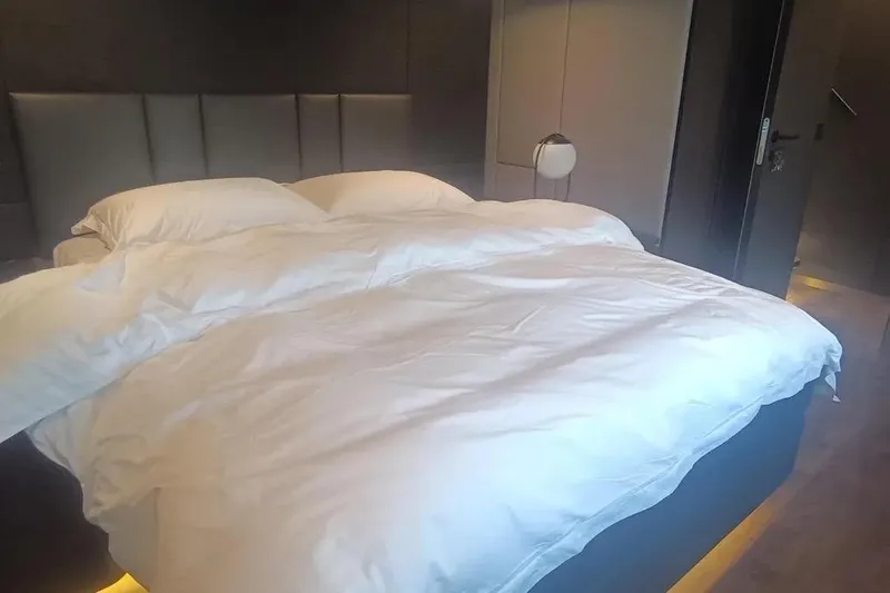  Yacht Photos Pics Luxurious bedroom interior on 2021 Sunreef 80 Power yacht, featuring a plush bed and modern design.