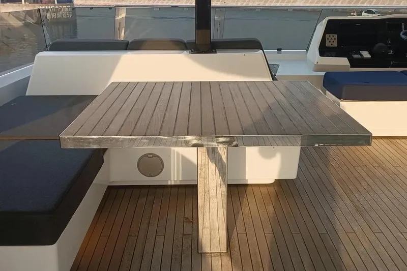  Yacht Photos Pics Sunreef 80 Power 2021 yacht deck with wooden table and seating area.