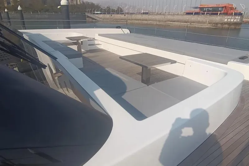  Yacht Photos Pics Sunreef 80 Power 2021 yacht deck with seating and tables, docked at a marina.