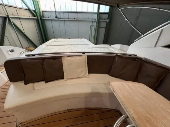  Yacht Photos Pics Sessa Marine C 48 2013 model boat interior with cushioned seating and wooden table.