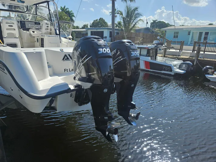  Yacht Photos Pics 2005 Boston Whaler 305 Conquest with twin 300 horsepower engines docked in sunny marina.