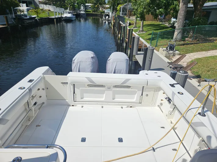  Yacht Photos Pics 2005 Boston Whaler 305 Conquest boat docked by a serene canal.