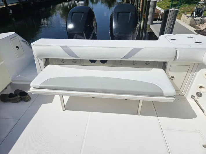  Yacht Photos Pics 2005 Boston Whaler 305 Conquest boat interior with foldable bench seat and twin engines.