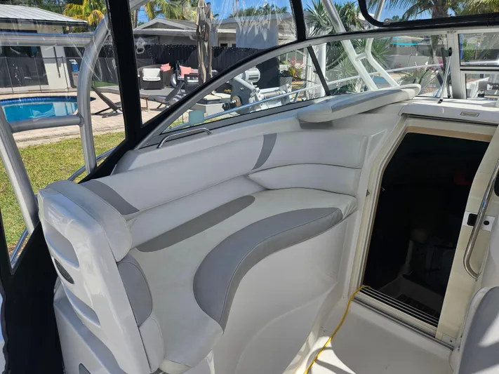  Yacht Photos Pics 2005 Boston Whaler 305 Conquest interior with white seating and cabin entrance.