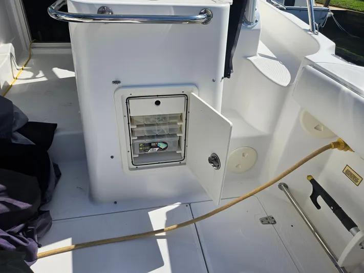  Yacht Photos Pics 2005 Boston Whaler 305 Conquest interior with open storage compartment and visible deck features.