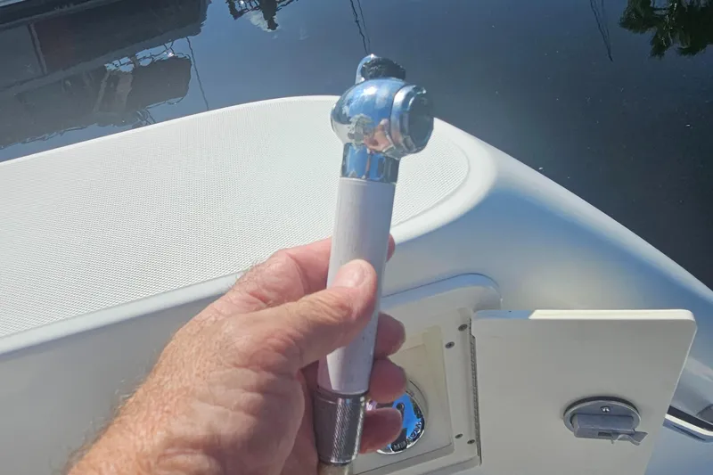  Yacht Photos Pics Hand holding a showerhead on a 2005 Boston Whaler 305 Conquest boat.