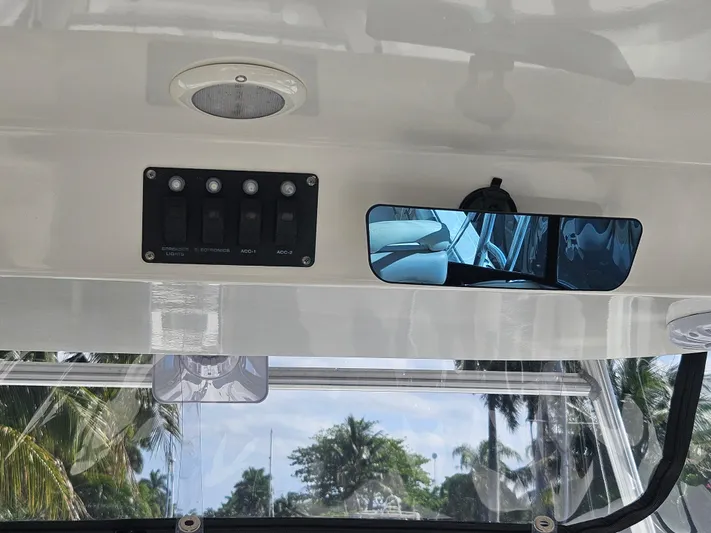  Yacht Photos Pics 2005 Boston Whaler 305 Conquest interior with control panel and rearview mirror.
