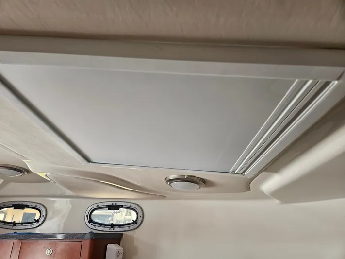  Yacht Photos Pics Interior ceiling of a 2005 Boston Whaler 305 Conquest boat with portholes and lighting.