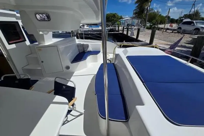 Sunbelievable Yacht Photos Pics Spacious deck of 2008 Fountaine Pajot Salina 48 Evolution catamaran with blue seating.