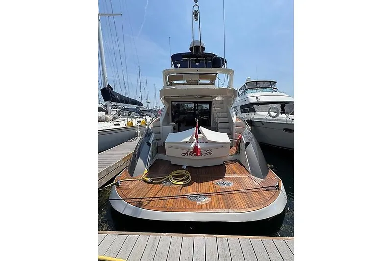  Yacht Photos Pics 2012 Marquis 500 Sport Bridge yacht docked at marina, rear view.