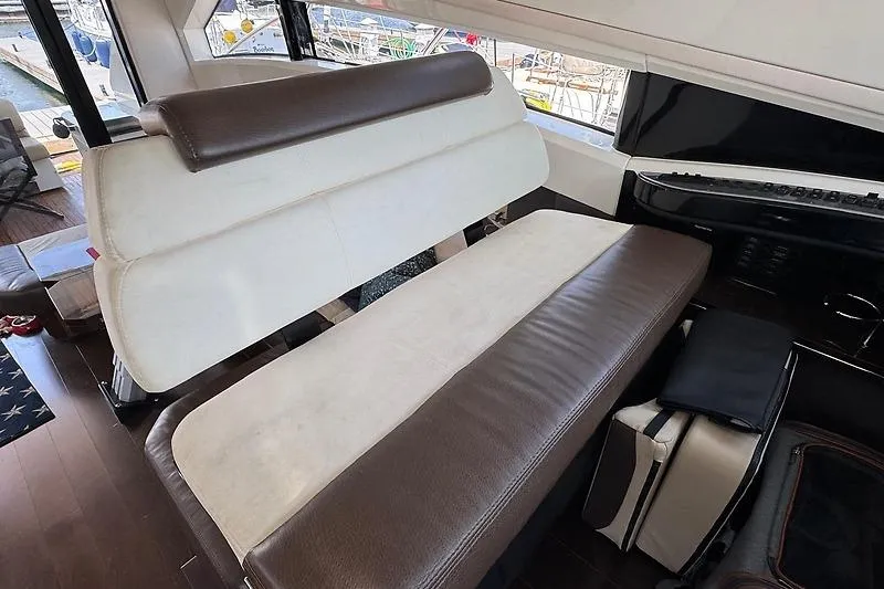  Yacht Photos Pics Interior seating of 2012 Marquis 500 Sport Bridge yacht, featuring brown and white upholstery.