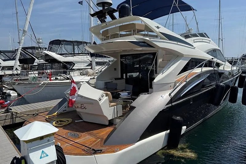  Yacht Photos Pics Luxury 2012 Marquis 500 Sport Bridge yacht docked at marina, featuring sleek design and Canadian flag.