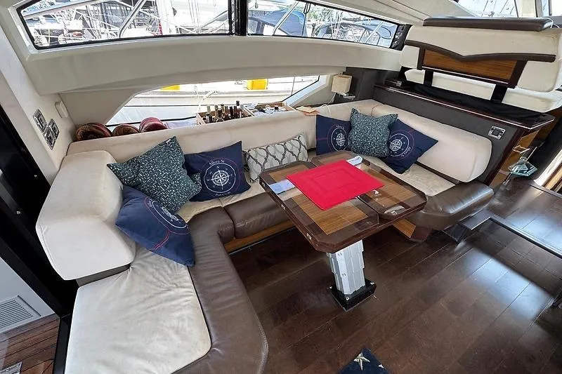  Yacht Photos Pics Luxurious interior of 2012 Marquis 500 Sport Bridge yacht with elegant seating and table.