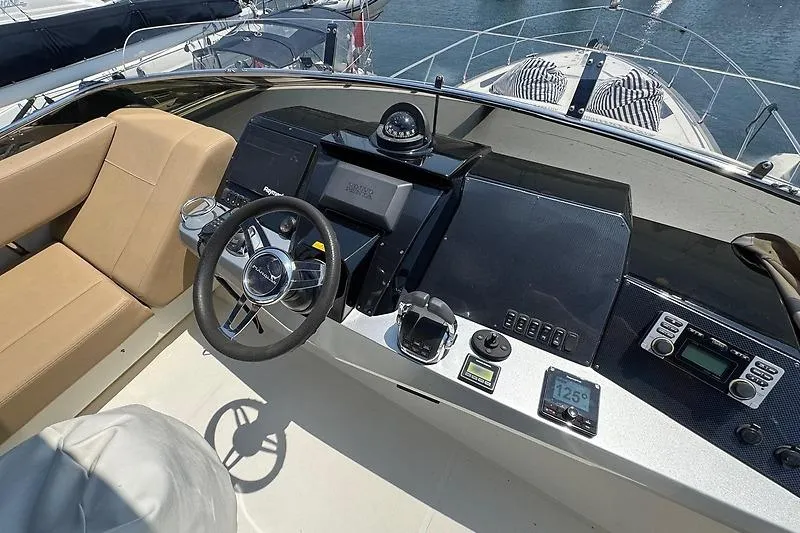  Yacht Photos Pics Helm of 2012 Marquis 500 Sport Bridge yacht with modern navigation equipment.