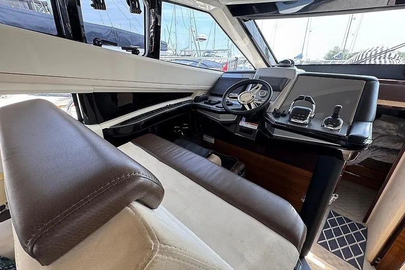  Yacht Photos Pics Interior of 2012 Marquis 500 Sport Bridge yacht showing helm and controls.