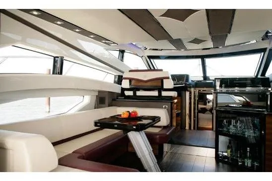  Yacht Photos Pics Luxurious interior of a 2012 Marquis 500 Sport Bridge yacht with modern seating and dining area.