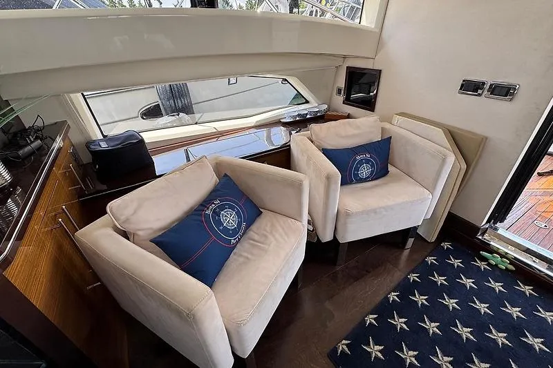  Yacht Photos Pics Luxurious interior of 2012 Marquis 500 Sport Bridge yacht with plush seating and nautical decor.