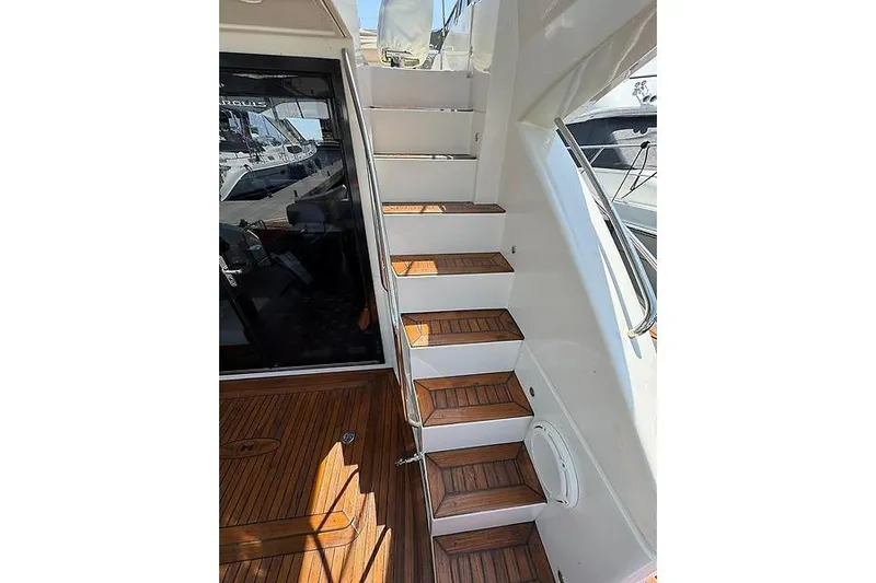  Yacht Photos Pics Staircase on 2012 Marquis 500 Sport Bridge yacht with wooden steps and sleek design.
