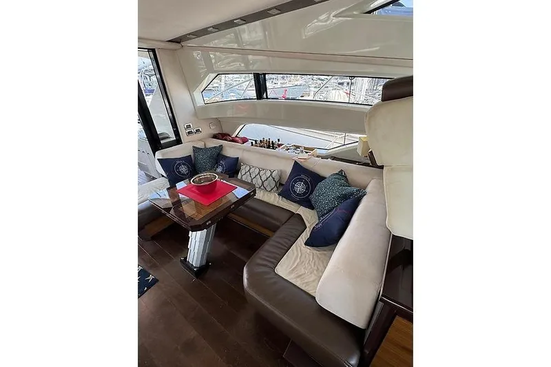  Yacht Photos Pics Luxurious interior of 2012 Marquis 500 Sport Bridge yacht with elegant seating and table.