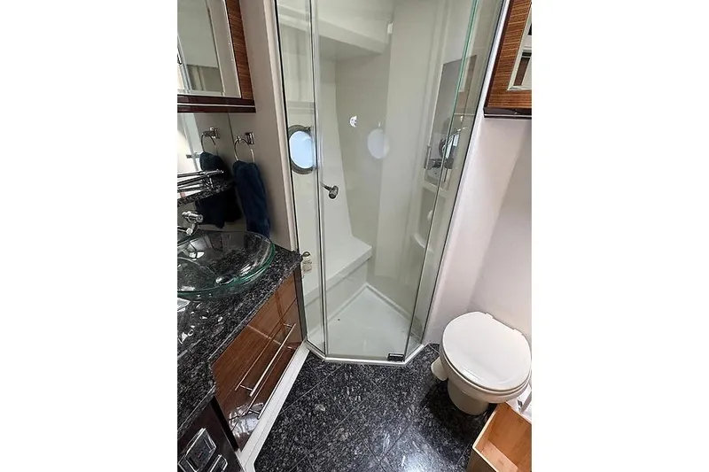  Yacht Photos Pics Luxurious bathroom in 2012 Marquis 500 Sport Bridge yacht with glass shower and modern fixtures.