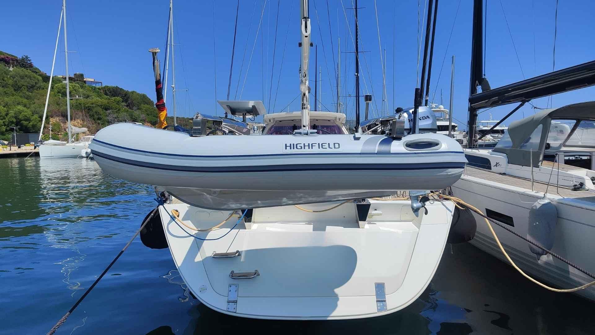 Sailboat Amel 55 (2017) with Highfield dinghy docked at marina.