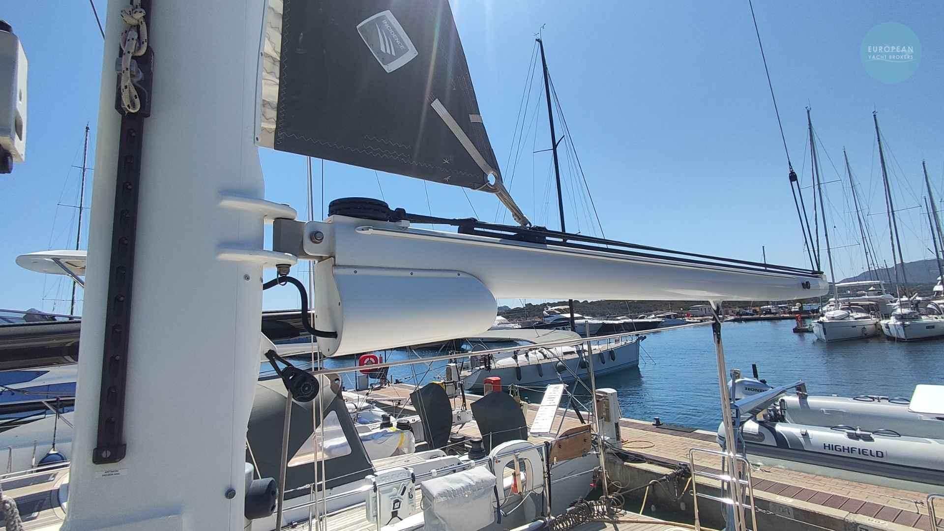 Sailboat Amel 55, 2017 model, docked at marina with clear blue sky.