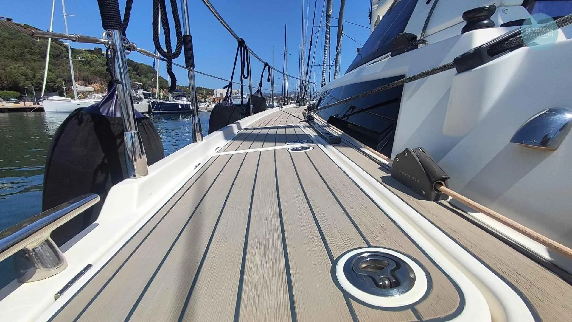 Deck view of 2017 Amel 55 yacht docked in a marina.