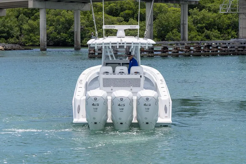  Yacht Photos Pics 2023 Contender 39 ST boat with triple outboard engines on the water.
