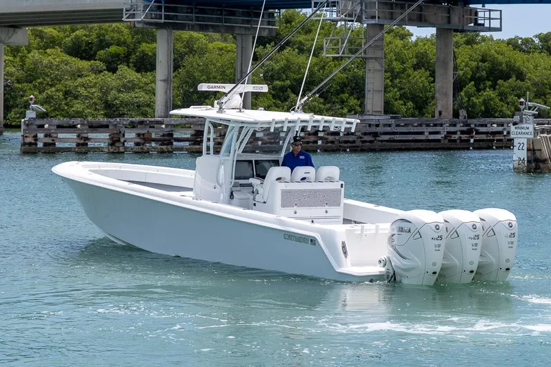  Yacht Photos Pics 2023 Contender 39 ST boat with four engines cruising on a calm waterway.