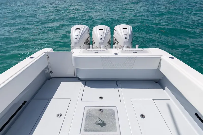  Yacht Photos Pics 2023 Contender 39 ST boat with triple outboard engines on open water.