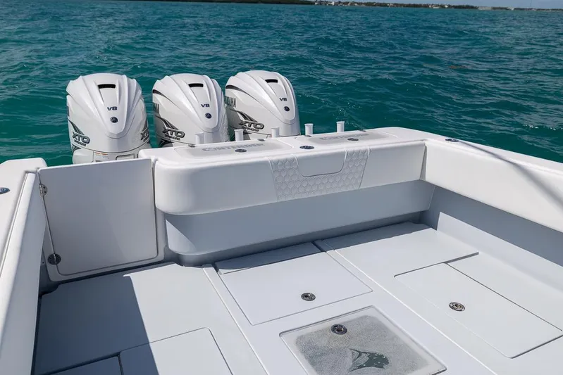  Yacht Photos Pics 2023 Contender 39 ST boat with triple outboard engines on open water.