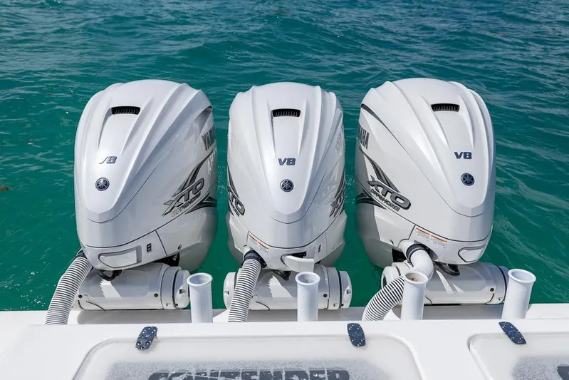  Yacht Photos Pics Triple Yamaha V8 outboard engines on a 2023 Contender 39 ST boat in clear blue water.