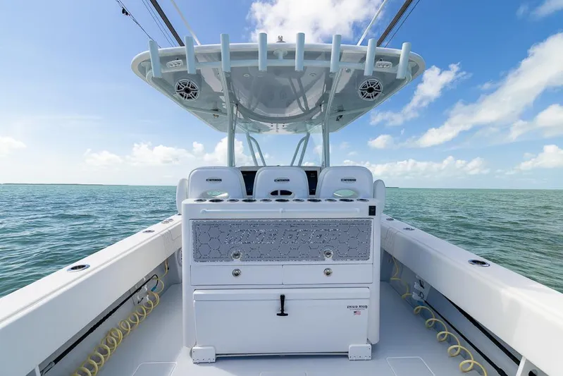  Yacht Photos Pics 2023 Contender 39 ST boat on open water under clear blue sky.