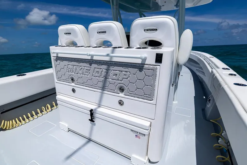  Yacht Photos Pics 2023 Contender 39 ST boat interior with seating and storage, ocean backdrop.