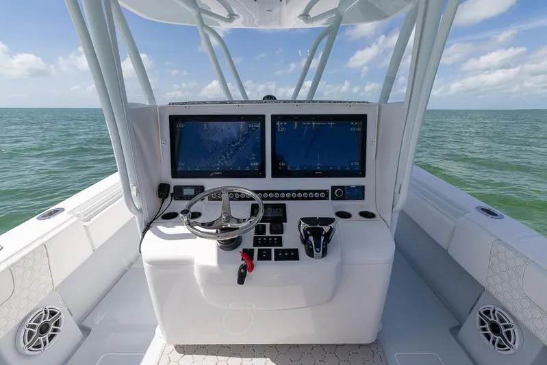  Yacht Photos Pics 2023 Contender 39 ST boat dashboard with dual screens on open water.