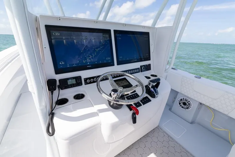  Yacht Photos Pics Helm of 2023 Contender 39 ST boat with dual screens and steering wheel.