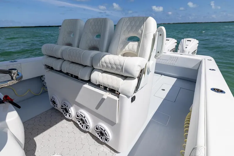  Yacht Photos Pics 2023 Contender 39 ST boat interior with plush seating and ocean backdrop.