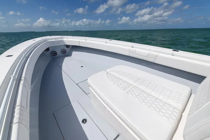  Yacht Photos Pics 2023 Contender 39 ST boat interior with white seating, ocean view, and clear sky.